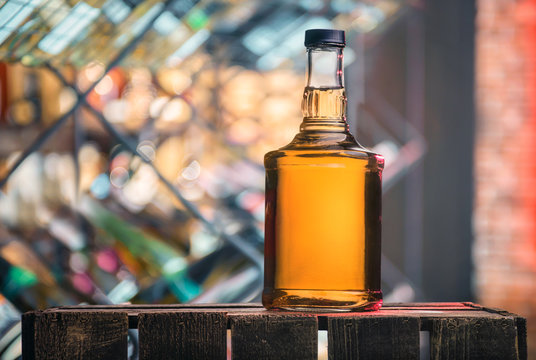 A bottle of whiskey on a wooden box