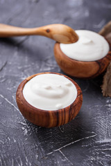 White Greek yogurt in wooden bowl