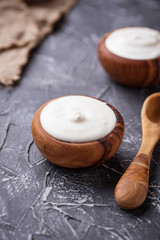 Obraz na płótnie Canvas White Greek yogurt in wooden bowl