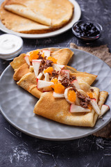 Pancakes crepes with different fruits and chocolate