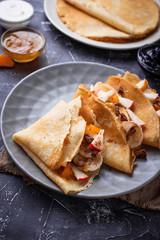 Pancakes crepes with different fruits and chocolate