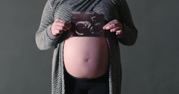 Maternity Ultrasound Photo Woman Holding Picture in Front of Belly Baby Bump