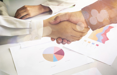 Businessmen shaking hands during a meeting.