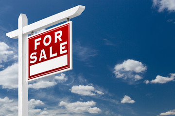 Right Facing For Sale Real Estate Sign Over Blue Sky and Clouds With Room For Your Text.