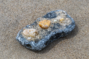 Beautiful natural stone on the sand, closeup 