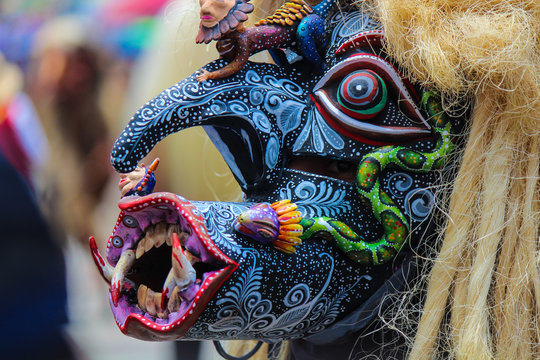 terrifying and monstrous black ando blue mask of warrior "tastoan" with many hand-painted details of a traditional Mexican carnival