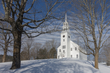 Fototapeta na wymiar White Vermont Church on a Snowy Hill