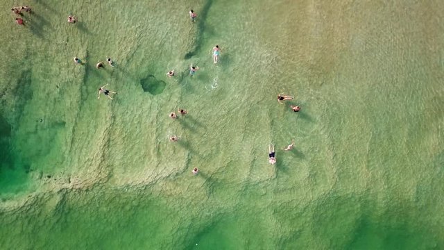 Top down aerial footage of people floating in the salty water of the Dead Sea, Israel.