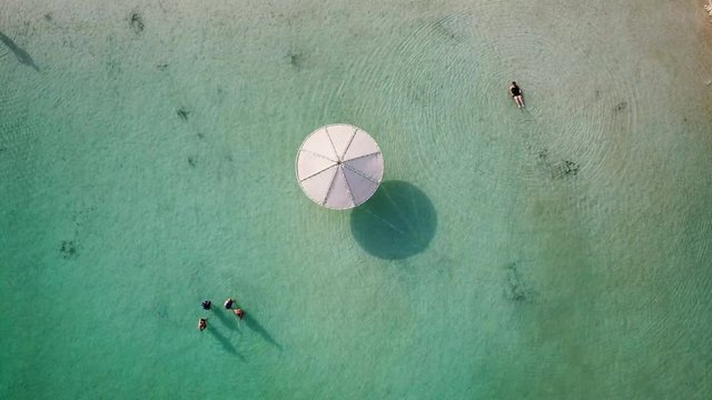 Top down aerial footage of people floating in the salty water of the Dead Sea, Israel.
