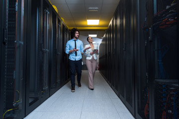 engineer showing working data center server room to female chief