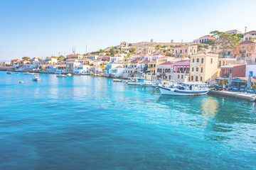 Fototapeta na wymiar Boats in port of town Emporio (Nimborio) - capital of island of Halki (GREECE)