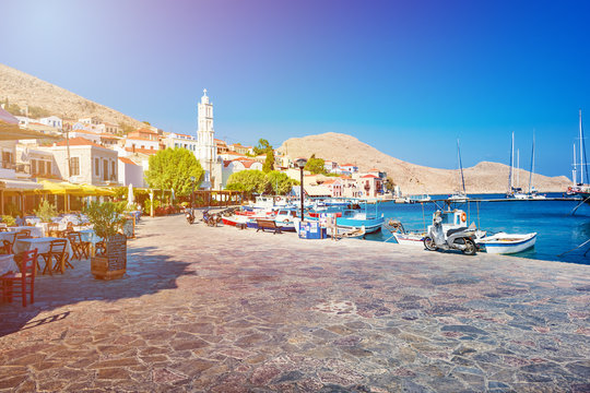 Boats and bell tower in port of Emporio (Nimborio) - capital of island of Halki (GREECE)