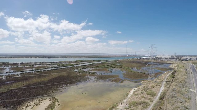 Drone footage of remote industrial area near power station and high-voltage towers, taken at Outer Harbor, Port Adelaide, South Australia.