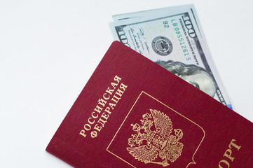 Two banknotes of 100 american dollars each, lying in the Russian passport on a white background