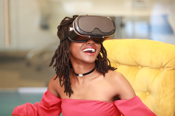 Joyful black female enjoying virtual reality