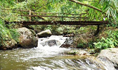 wood bridge over Chae Son waterfall in Chae Son National Park in Lampang Province, Thailand