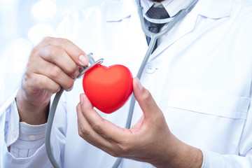 check up on a red heart ball on blur office in the hospital and bokeh background. Concept of health...