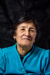 portrait of an elderly thoughtful woman on a dark background