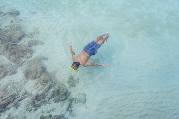 Asian man scubra driving to see coral under sea at KohKham Island,Trad,Thailand