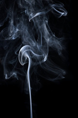 ฺฺAbstract motion of white smoke isolated on black background.