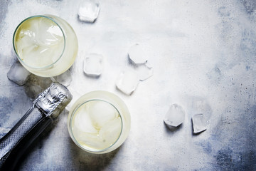 Festive Alcoholic Cocktail Prosecco On The Rocks With Dry Sparkling Wine And Ice Cubes, Gray Stone Background, Top View