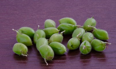 green chickpeas on wooden floor