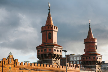 Fototapeta premium Towers of Oberbaum Bridge. This is a two-story bridge crossing the Berlin River Spree, considered one of the city landmarks in Berlin, Germany.