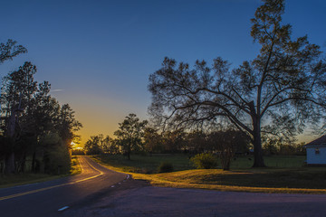 Fototapeta premium Sunset on the horizon of a road