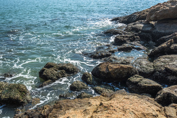 Sea waves splash on stones.