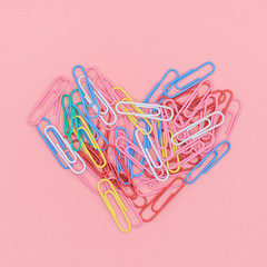 Heart of color paper clip with Paper red heart with Pink Pastel plastic texture background. Valentine concept. Minimal concept. Copy space