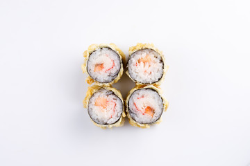Seductive baked sushi rolls with salmon and crab sticks top view.
