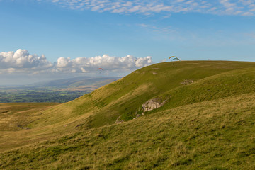 Fototapeta na wymiar Paragliding near the Nine Standards Rigg near Kirkby Stephen, Yorkshire Dales, Cumbria, UK