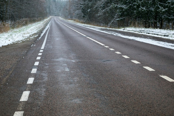 Morning road through snowy forest in Moscow Region, Russia