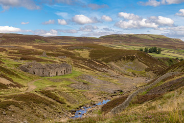 Yorkshire Dales landscape with the ruins of the Surrender Smelt Mill, between Feetham and Langthwaite, North Yorkshire, UK