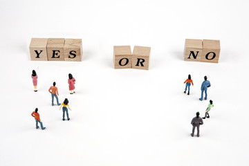 people standing at yes or no lettering cube on white background