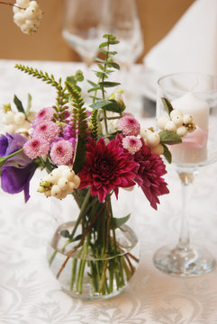 Beautiful Pink Flowers in Glass Vase on Wedding Table. flower Arrangement or Composition. Vertical Image.