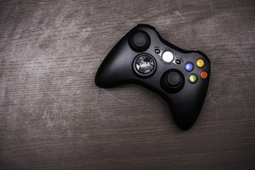 Joystick on wood background.