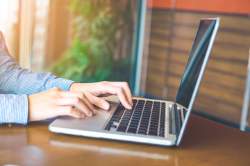 Woman hand working on laptop in the office.