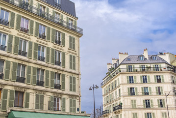 Fototapeta na wymiar Paris, beautiful building facades in a attractive area of the capital, green shutters 