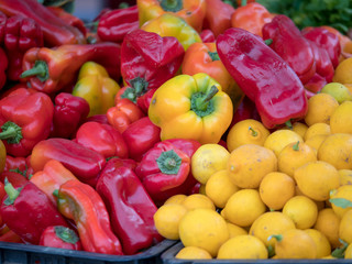 Red peppers and lemons on sale aon stand at farmer's market