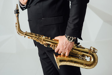 A man plays the saxophone close up