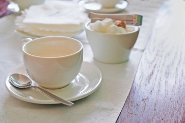 tea in a white mug on the table in a cafe