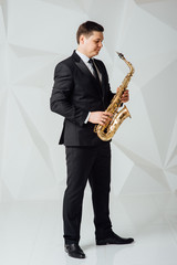 A man plays the saxophone close up
