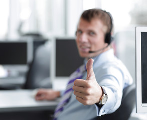 Happy male in headphones gesturing thumb up