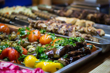 Street sale of food baked on the grill at the celebration. Selective focus