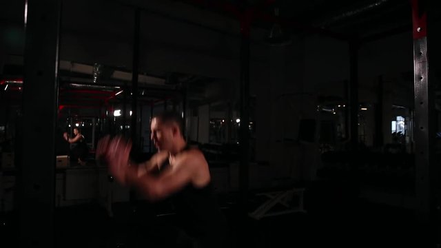 A professional athlete conducts cardio work. Performs harnessing on the kud in the gym.