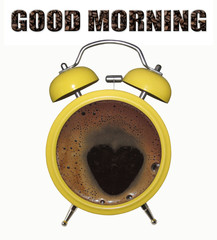There is a yellow alarm clock with black coffee. White background.