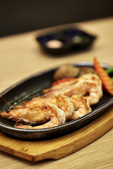 Japanese seafood. Fried spicy shrimps with herbs