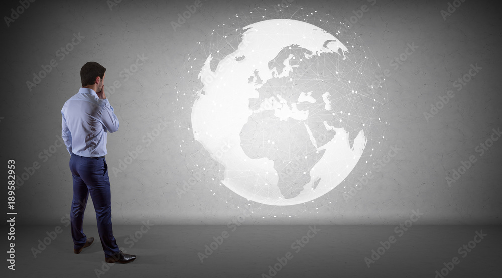 Poster Businessman using digital planet earth interface on a wall 3D rendering