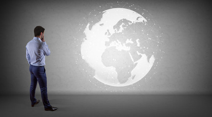 Businessman using digital planet earth interface on a wall 3D rendering